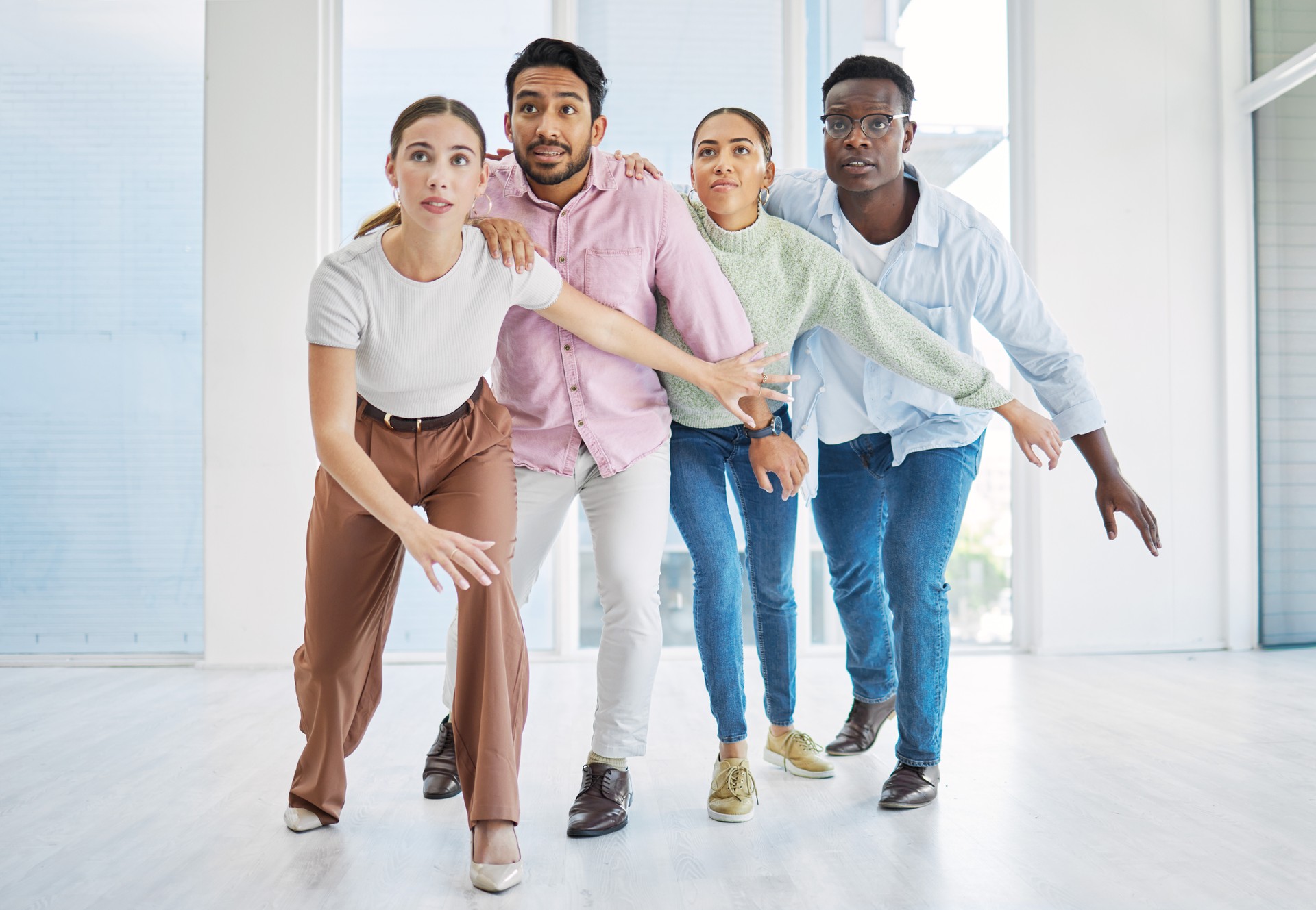 Dance, team building and business people together in collaboration, about us or pose in creative startup company office. Group, huddle and workers in solidarity, support and cooperation of designers
