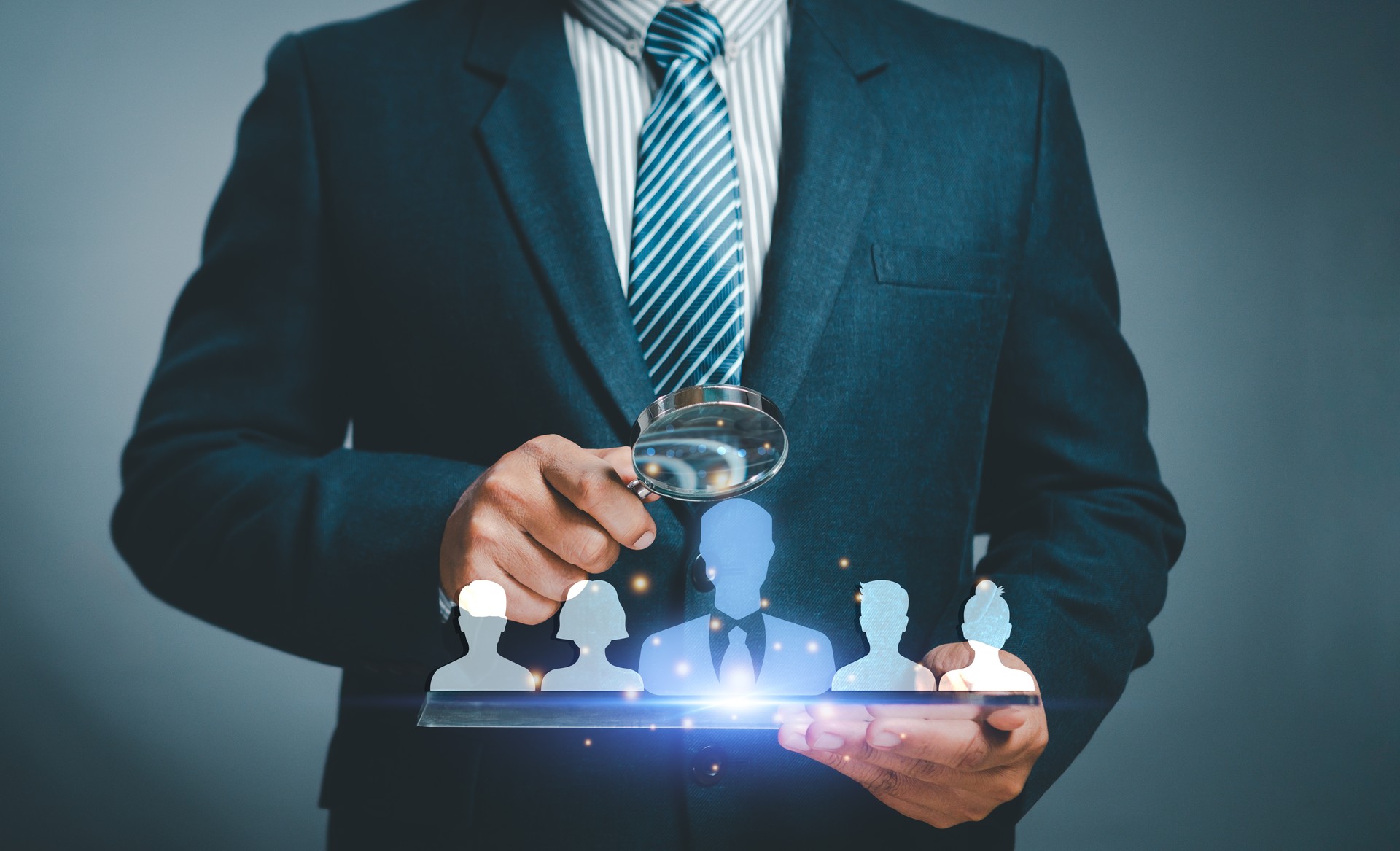 Human resource management concept. Businessman uses magnifying glass look employees teamwork business or Customer Relation Management focus target group social media. Digital marketing online. CRM